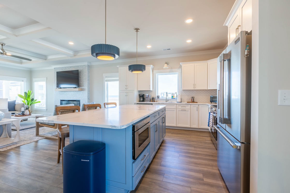 Kitchen with stainless appliances looking into the living room