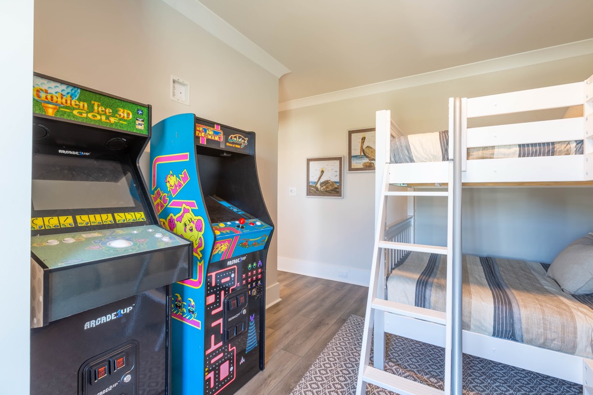 Bunk room with arcade games