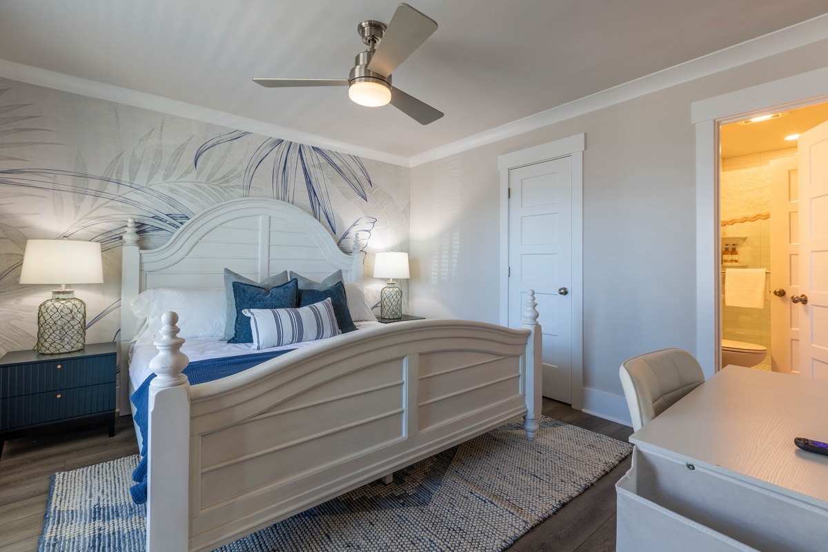 Bedroom with a palm-leaf mural and desk