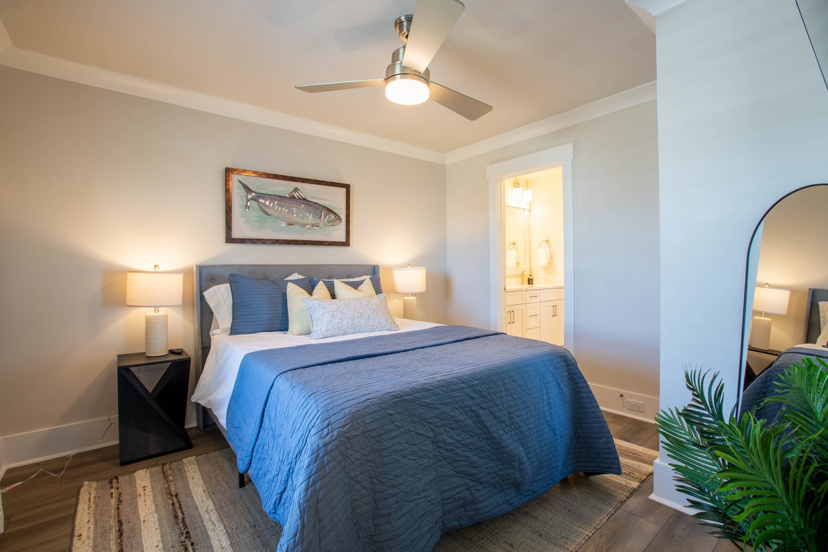 Bedroom with navy bedding and an en-suite bath