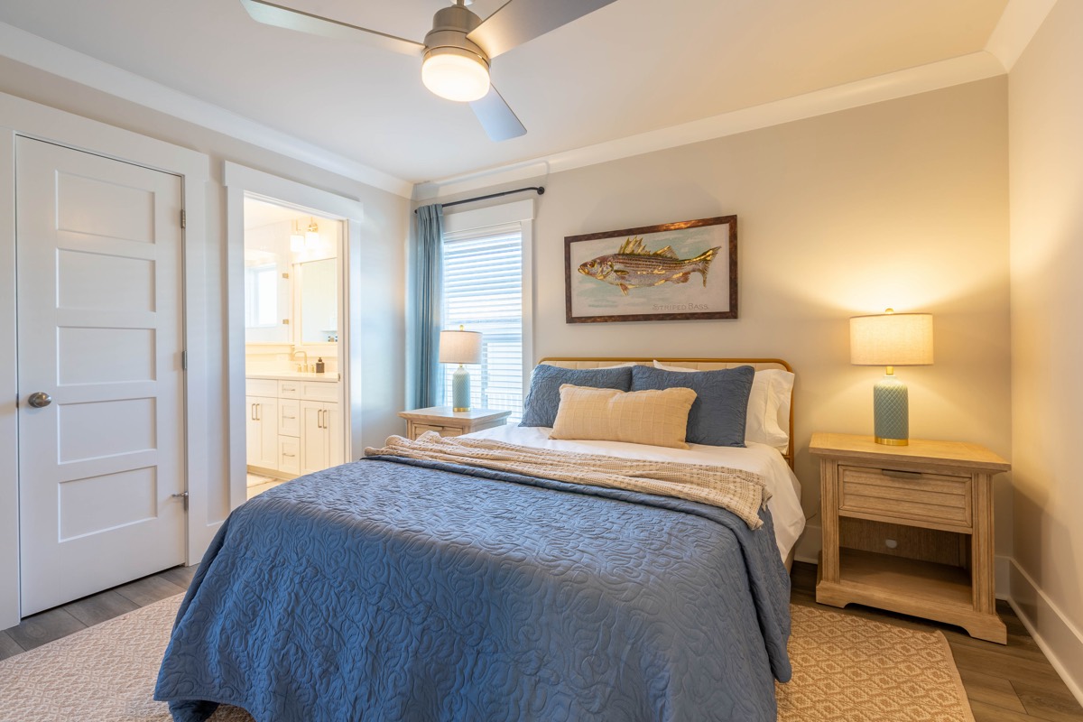 Bedroom with fish artwork and an en-suite bath