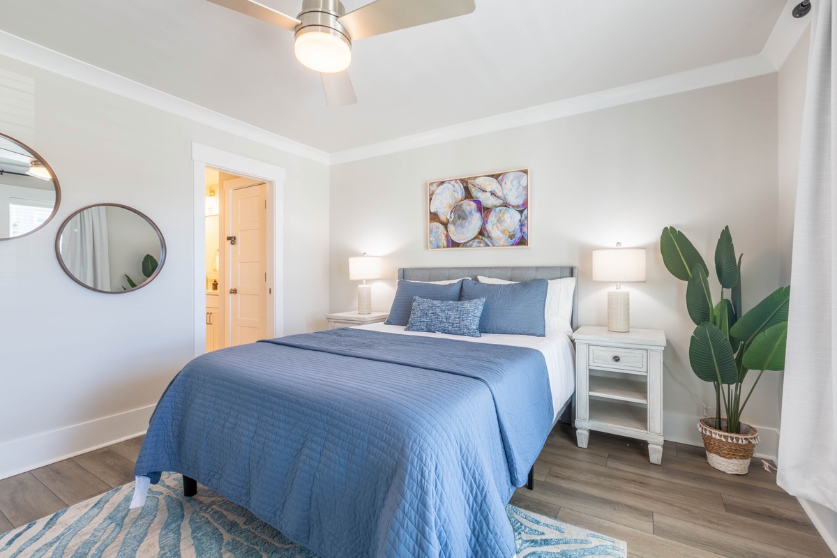 Bedroom with seashell artwork and round mirrors