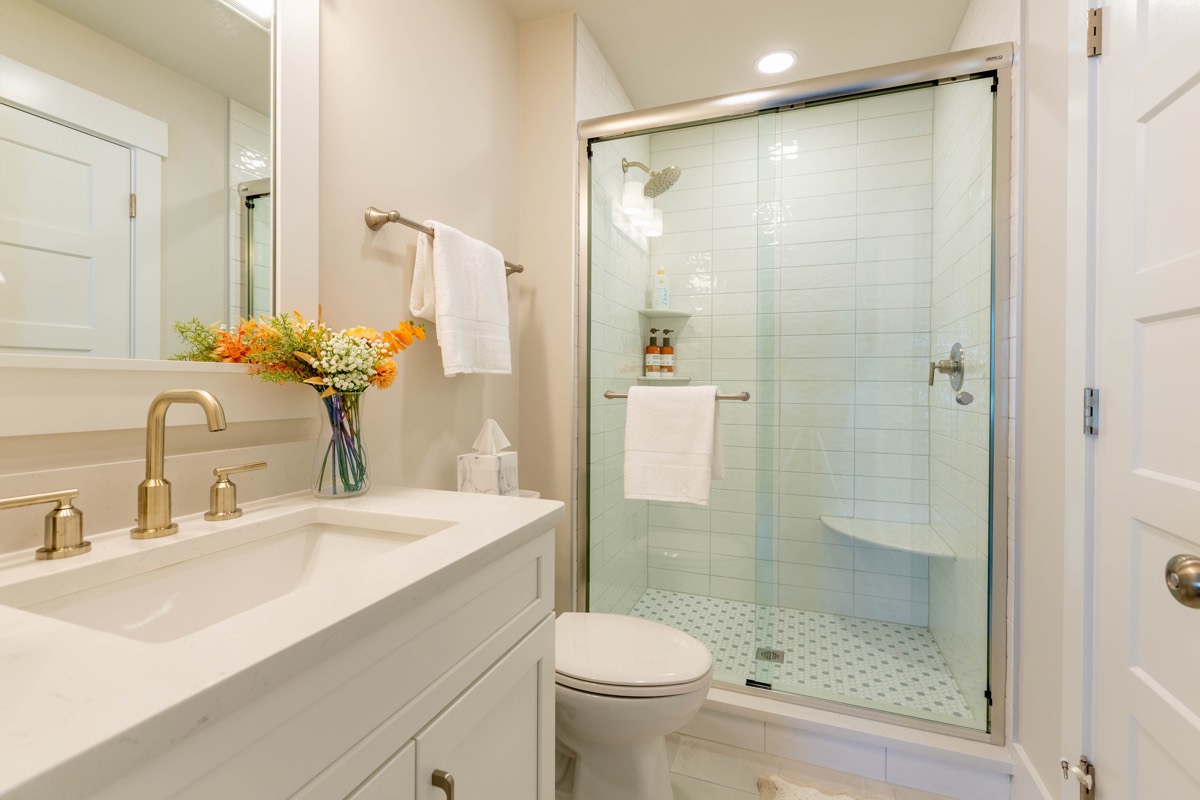 Bathroom with glass shower and brass fixtures
