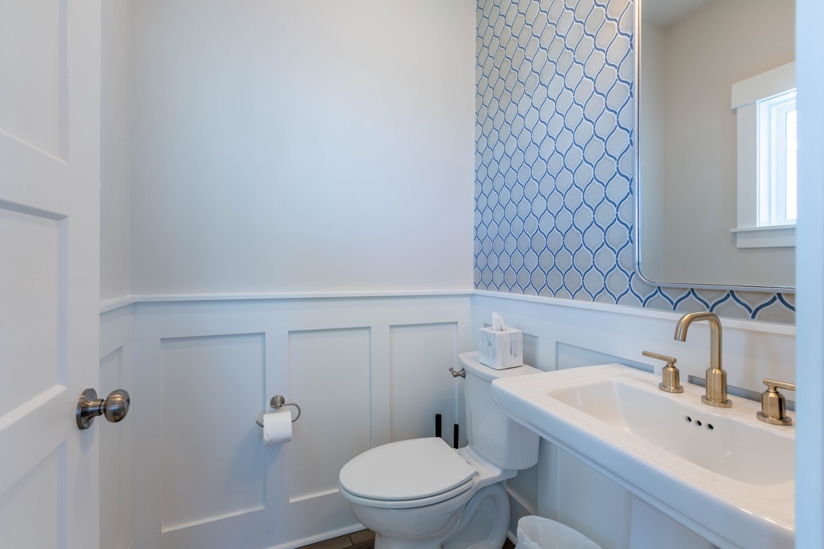 Half bath with patterned wallpaper